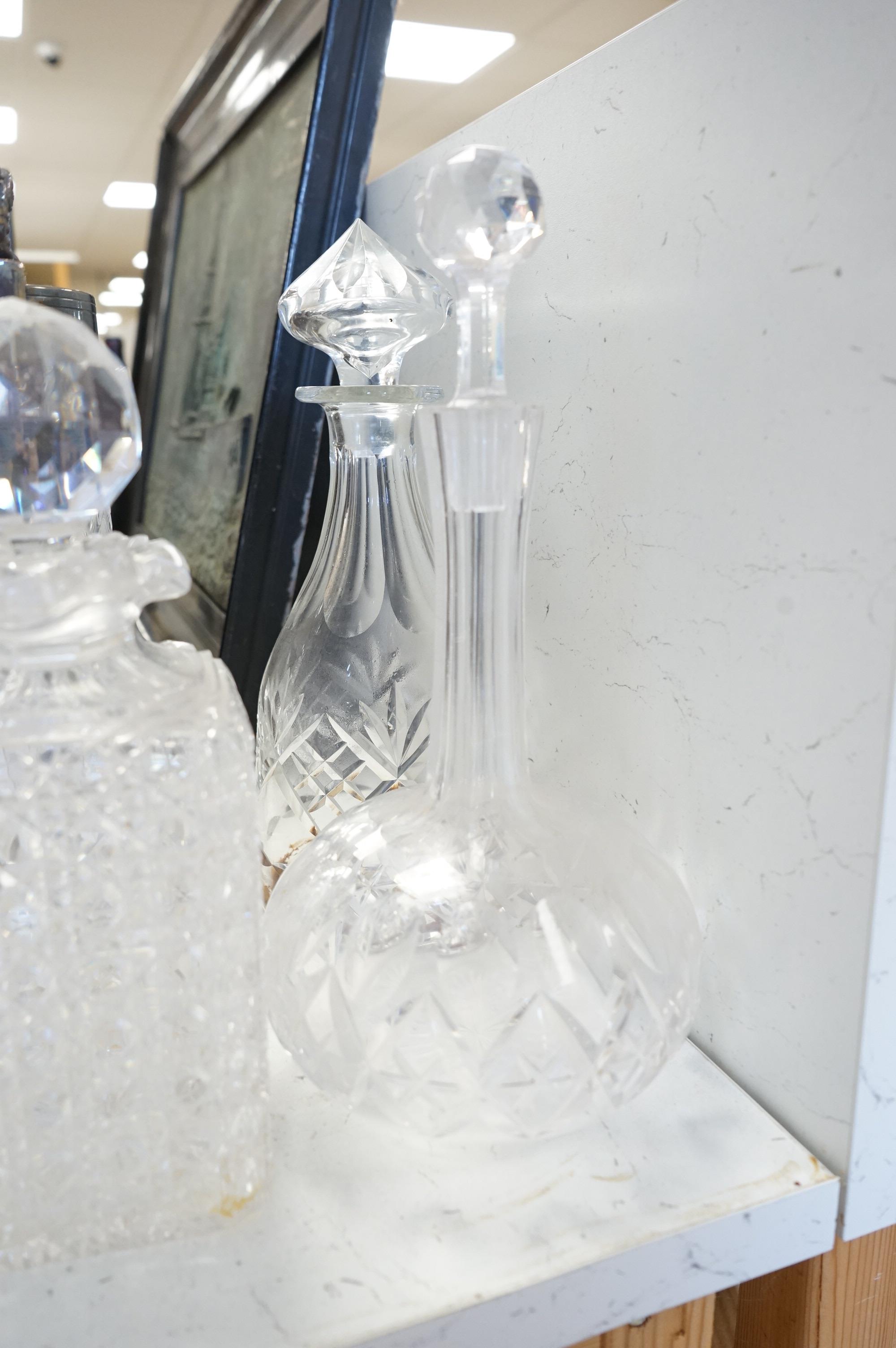 A collection of various cut glass to include decanters and a small pedestal bowl, largest 30cm high